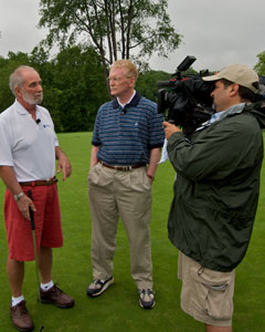 Bill Geist interviews a golfer at the Golf Classic